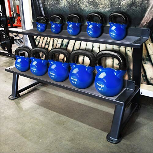 Blue kettlebells on a gym storage rack.