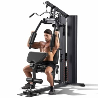 Man exercising on a home gym machine with multiple attachments